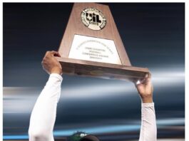 Coach holding a trophy