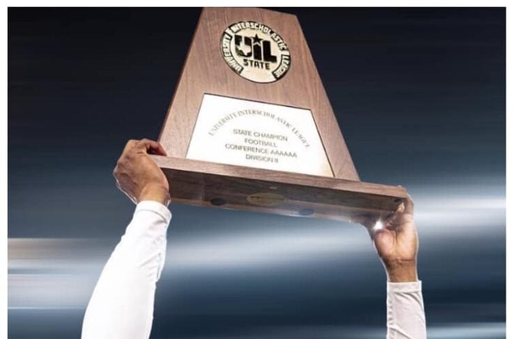 Coach holding a trophy