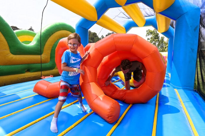 kid playing in giant bounce house