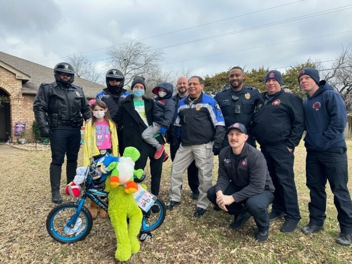 group of police officers with kids and a bike