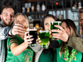 people toasting green beers
