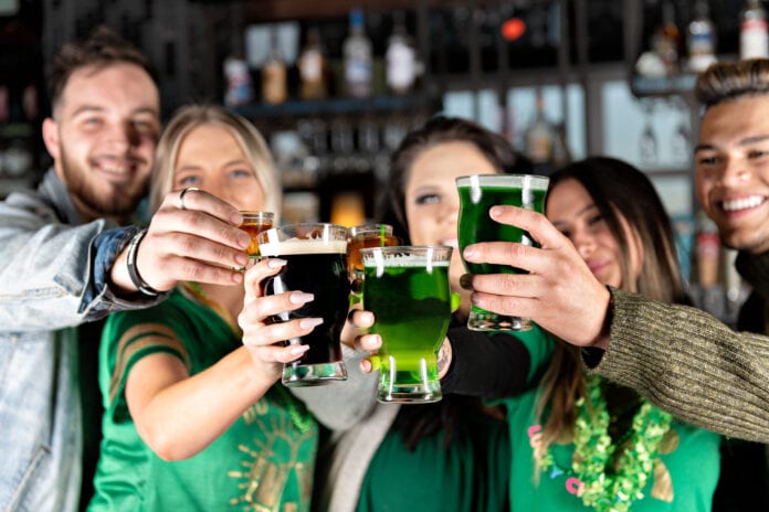 people toasting green beers