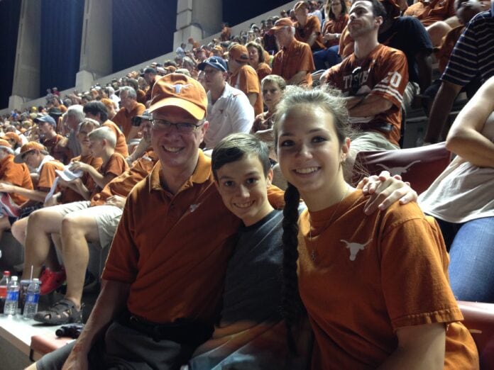 man boy and girl in UT gear