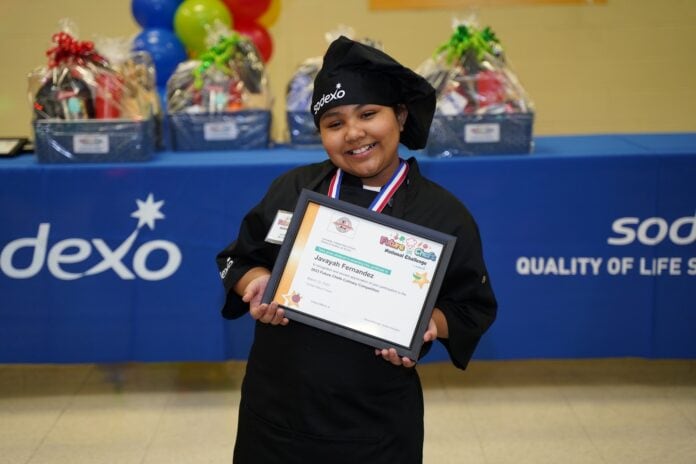 Javayah Fernandez with chef hat and winning certificate
