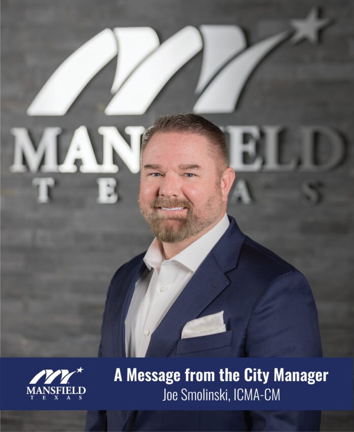 Joe Smolinski in front of Mansfield sign