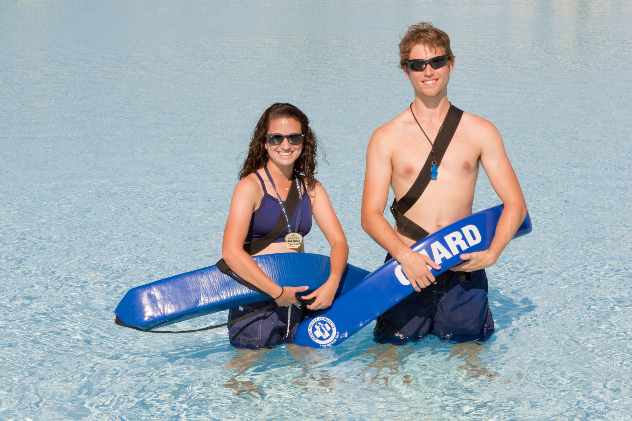 male and female lifeguards standing in water