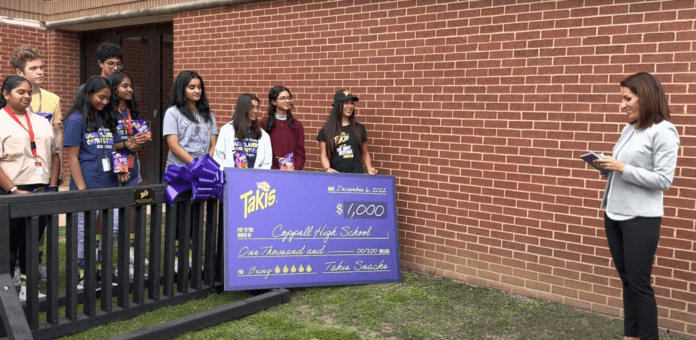 students standing with Takis bike rack and check