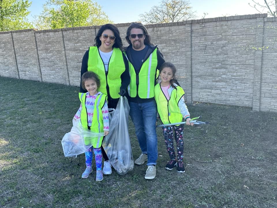 man woman with two children wearing safety vests