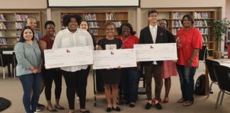Cedar Hill High PTSA Presents Shay Whittaker Scholarships students holding cardboard checks