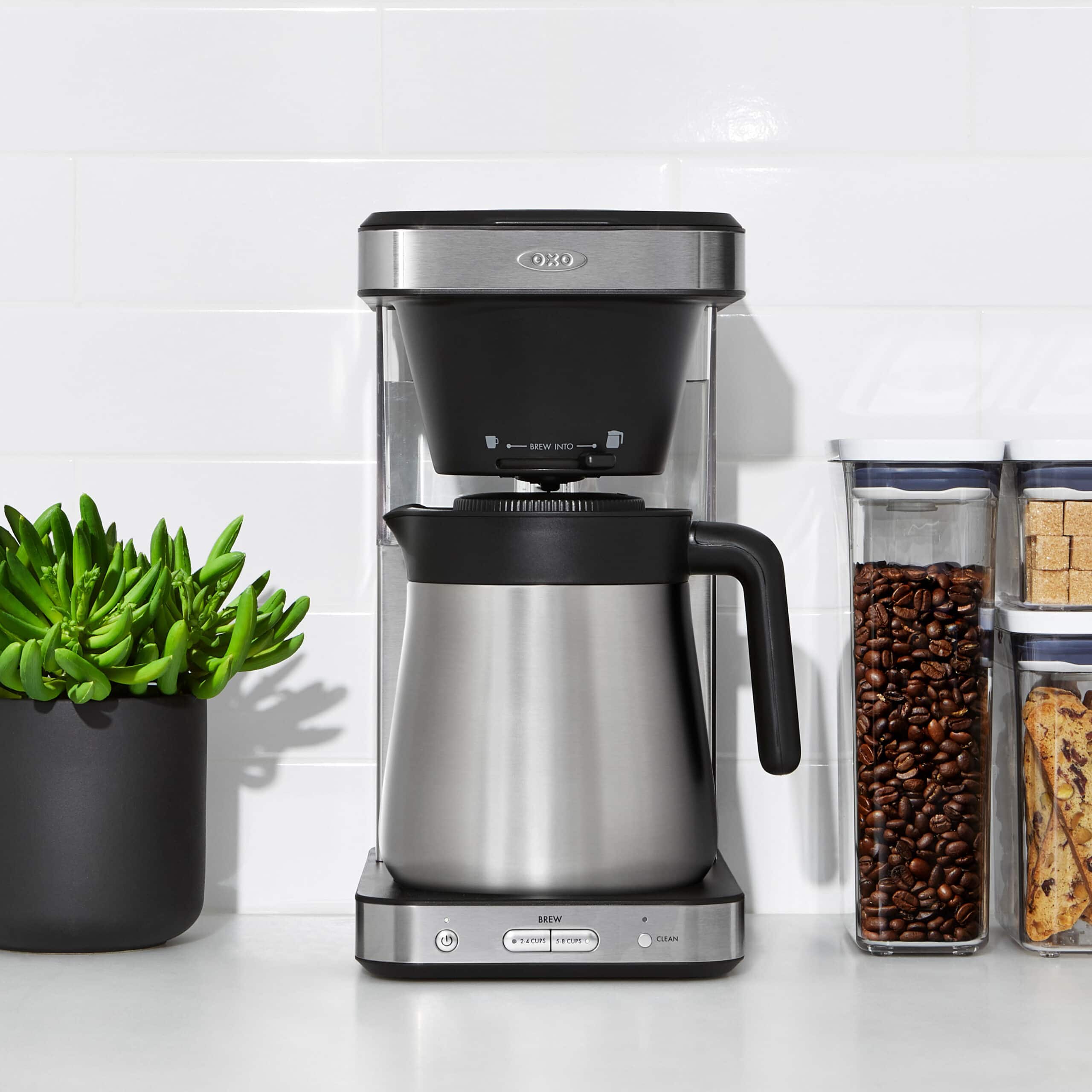 OXO 8 cup coffee maker next to a plant