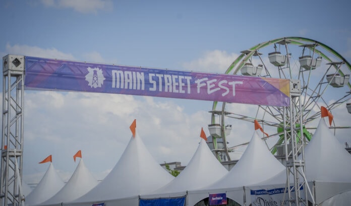 Main Street Fest banner with ferris wheel in background