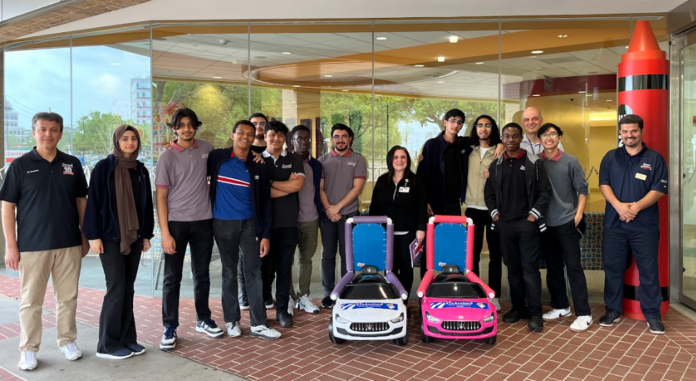 students with pink and white toy cars