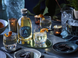 Astral Anejo tequila bottle and cocktail glasses