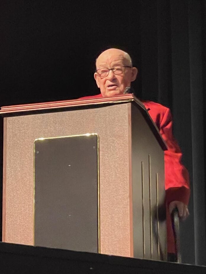 Raymond Dennis behind a lectern