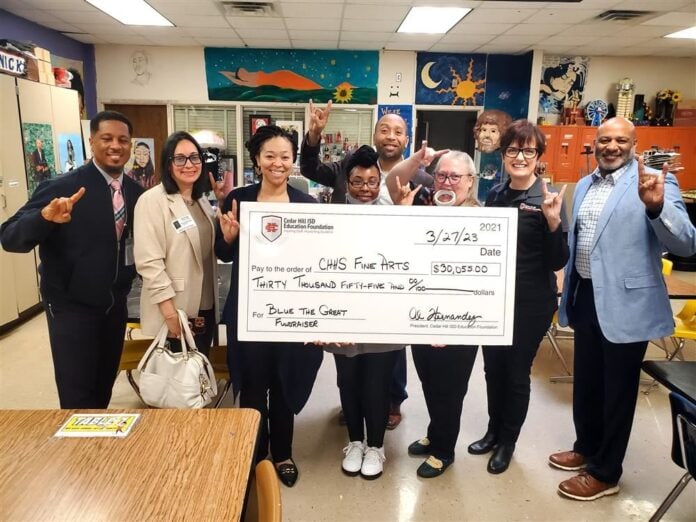 students with a cardboard check