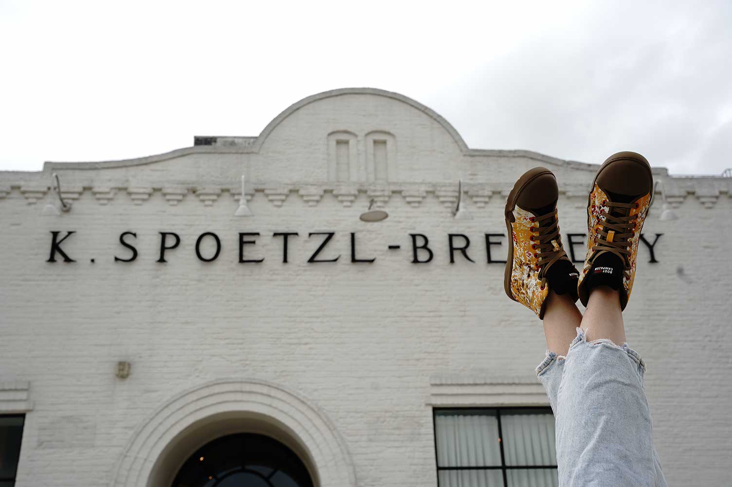 Shiner combat boots in front of brewery