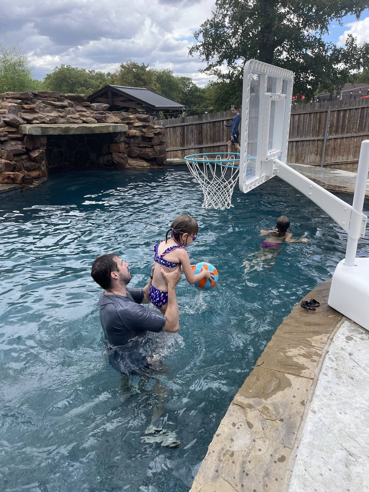 people playing basketball in pool