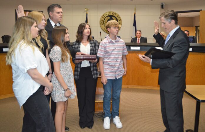 Justin Coffman with family takes oath