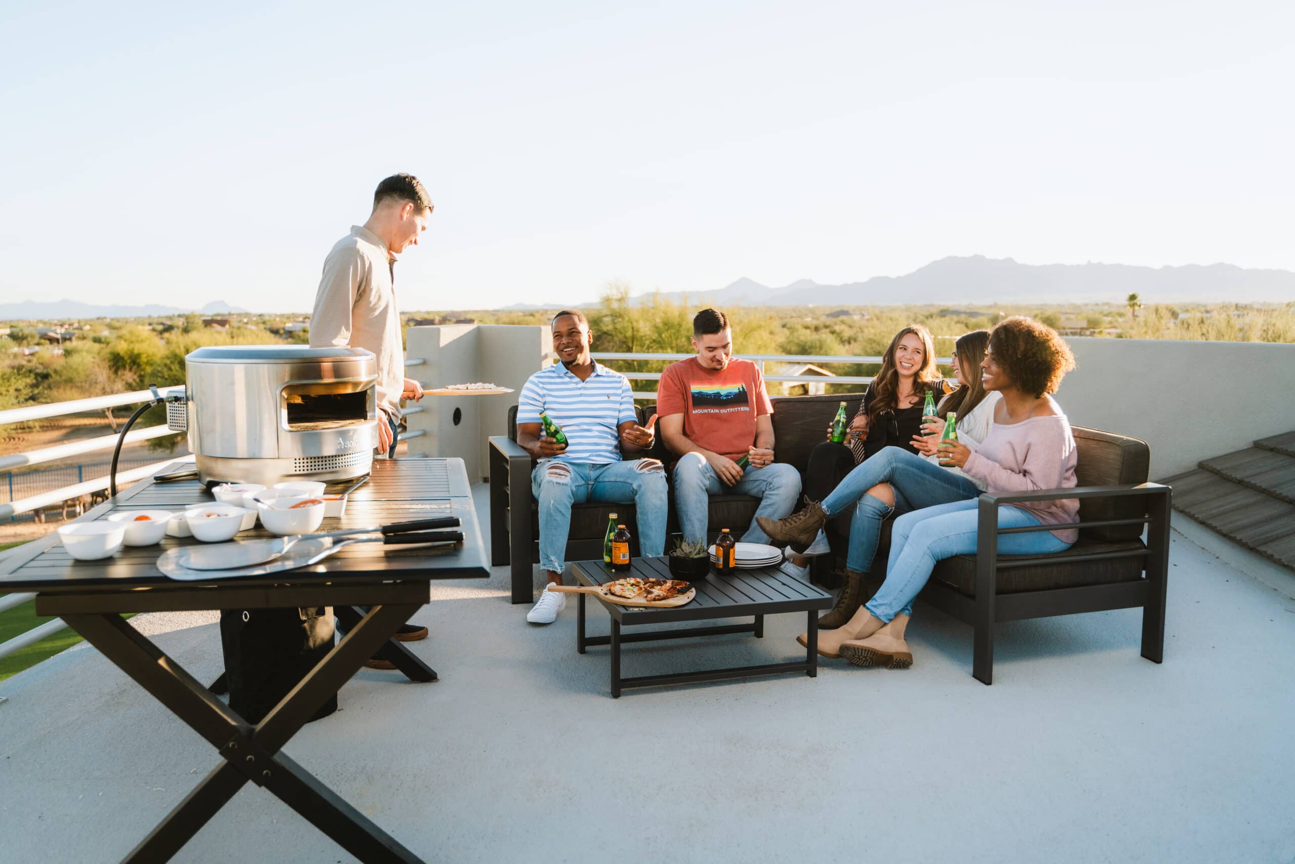 Pi pizza oven with people sitting outside