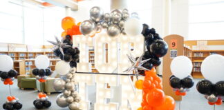 2023 Top 10 Graduating Students Of Lancaster ISD marquee letters with orange and black balloons