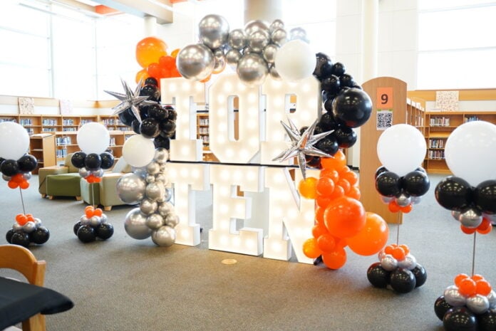 marquee letters with orange and black balloons