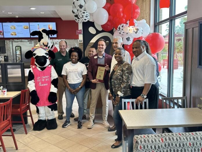 men and women with Chick fil A cow