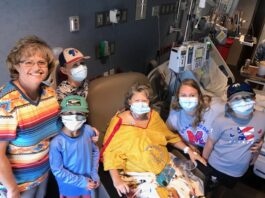 Tammy Chesley Howard in hospital surrounded by family