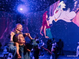 girl on Moms shoulders with Ariel art