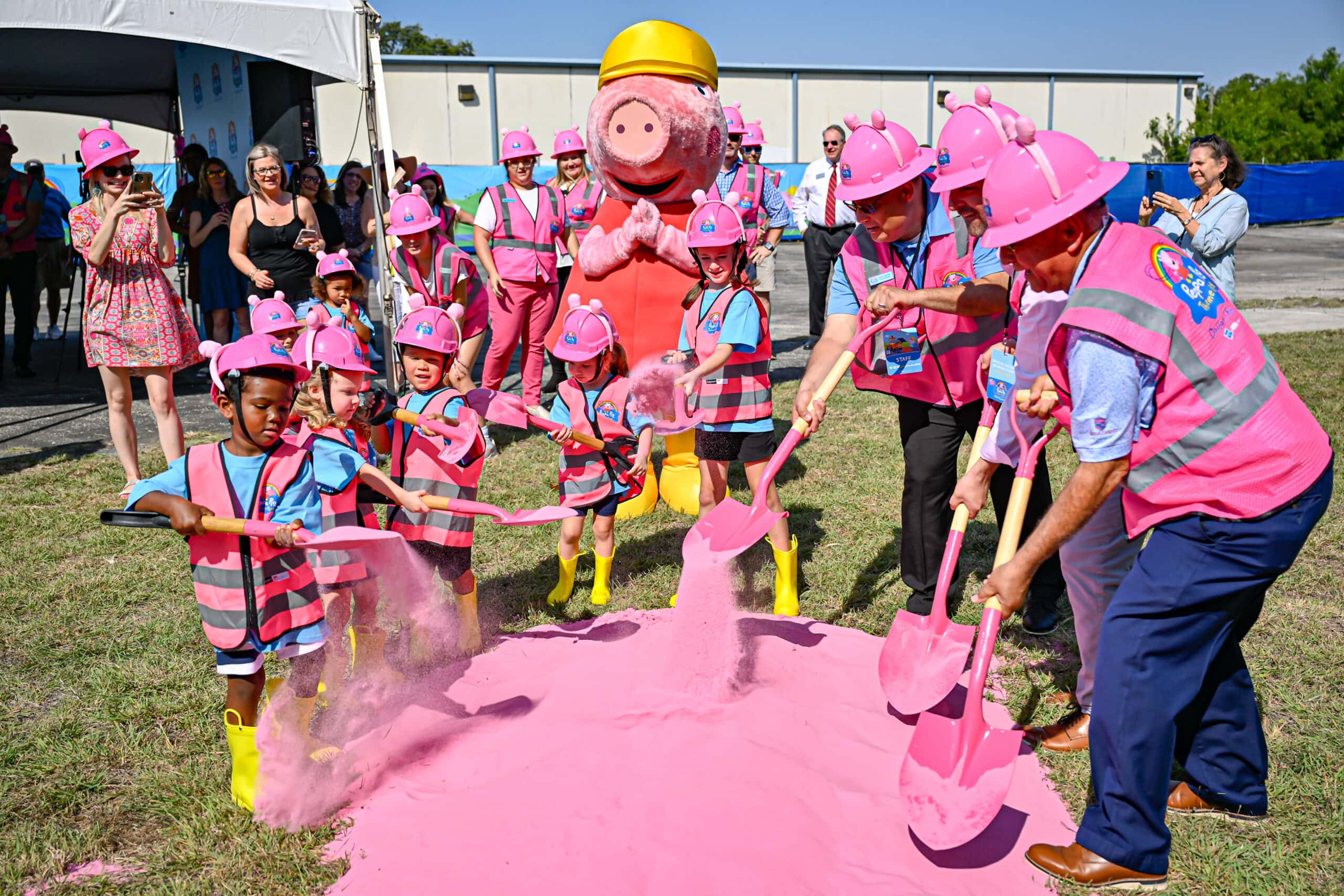 kids shovel pink sand with Peppa Pig