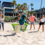 What Does Dad Want? Father’s Day Gift Guide people on beach playing PaddleSmash