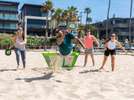 people on beach playing PaddleSmash