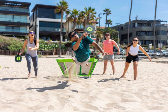 people on beach playing PaddleSmash