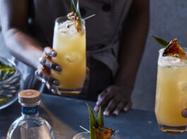 Pineapple cocktail with astral tequila bottle