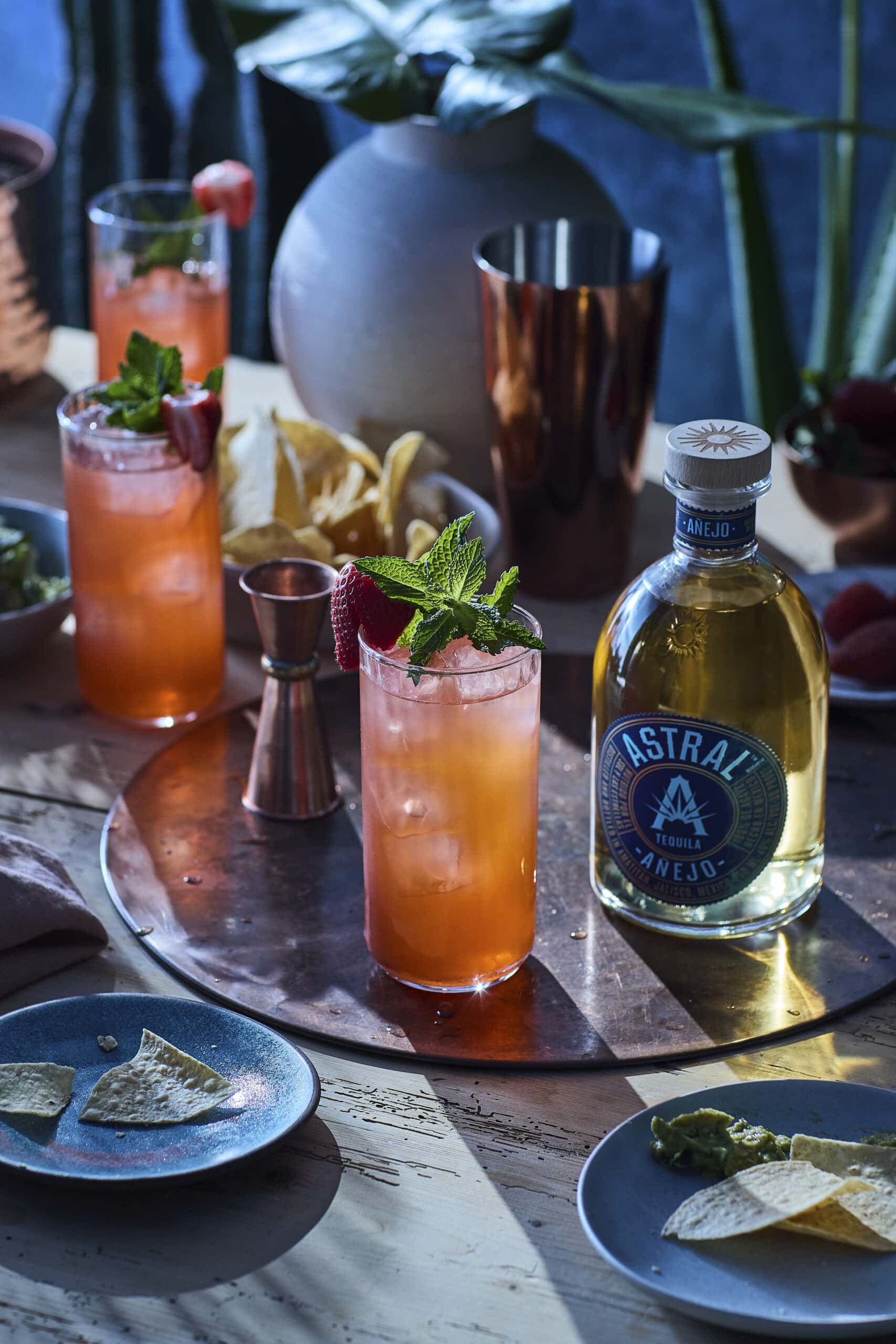 strawberry cocktail with Astral tequila bottle