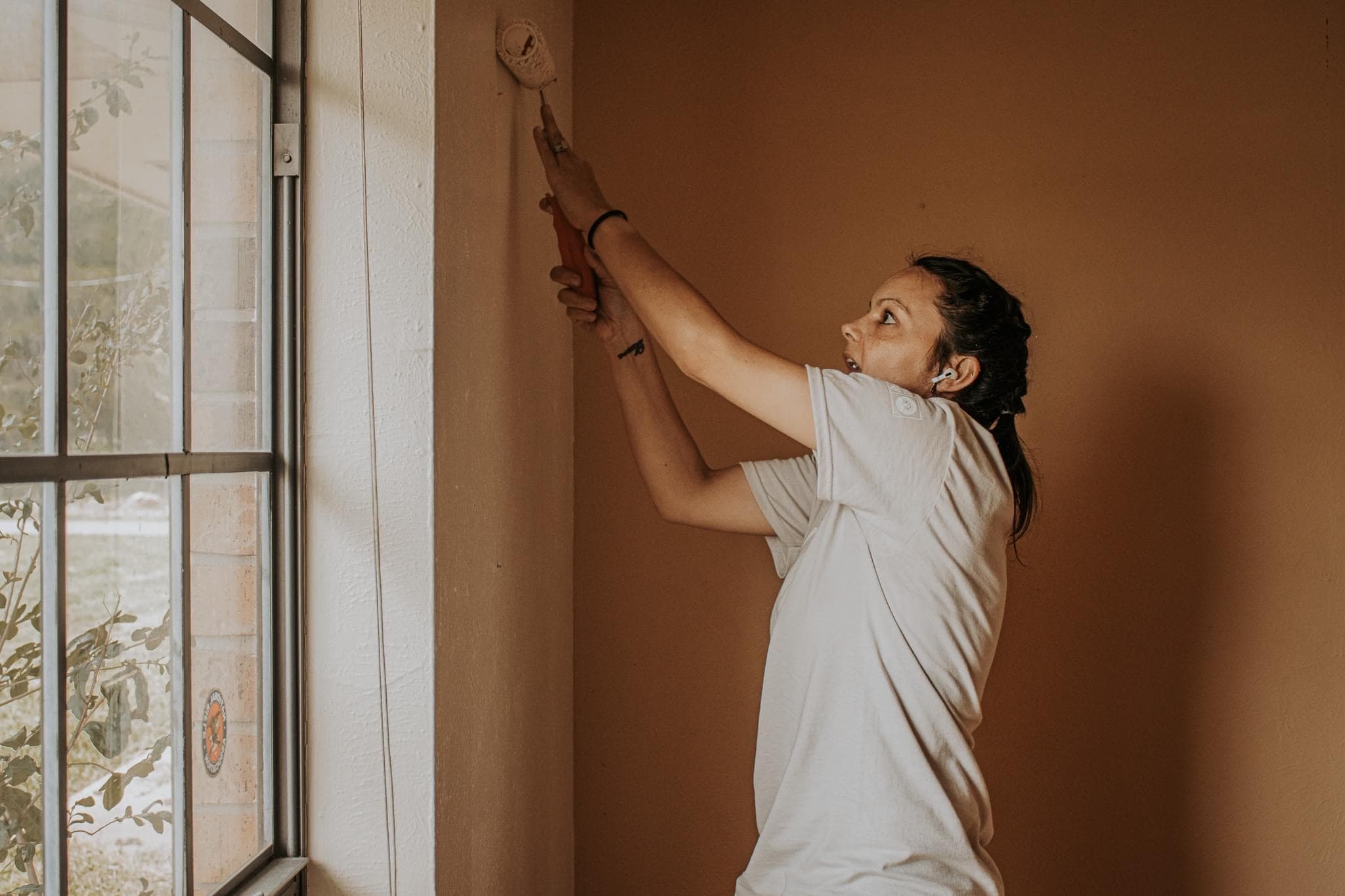 woman painting wall