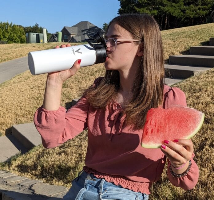 girl drinking Vitapod bottle