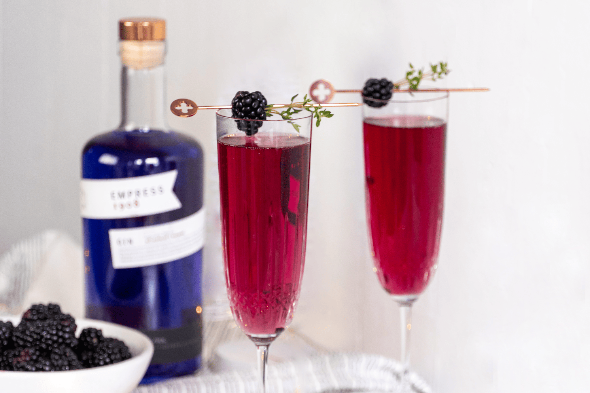 champagne glasses with berry colored cocktail