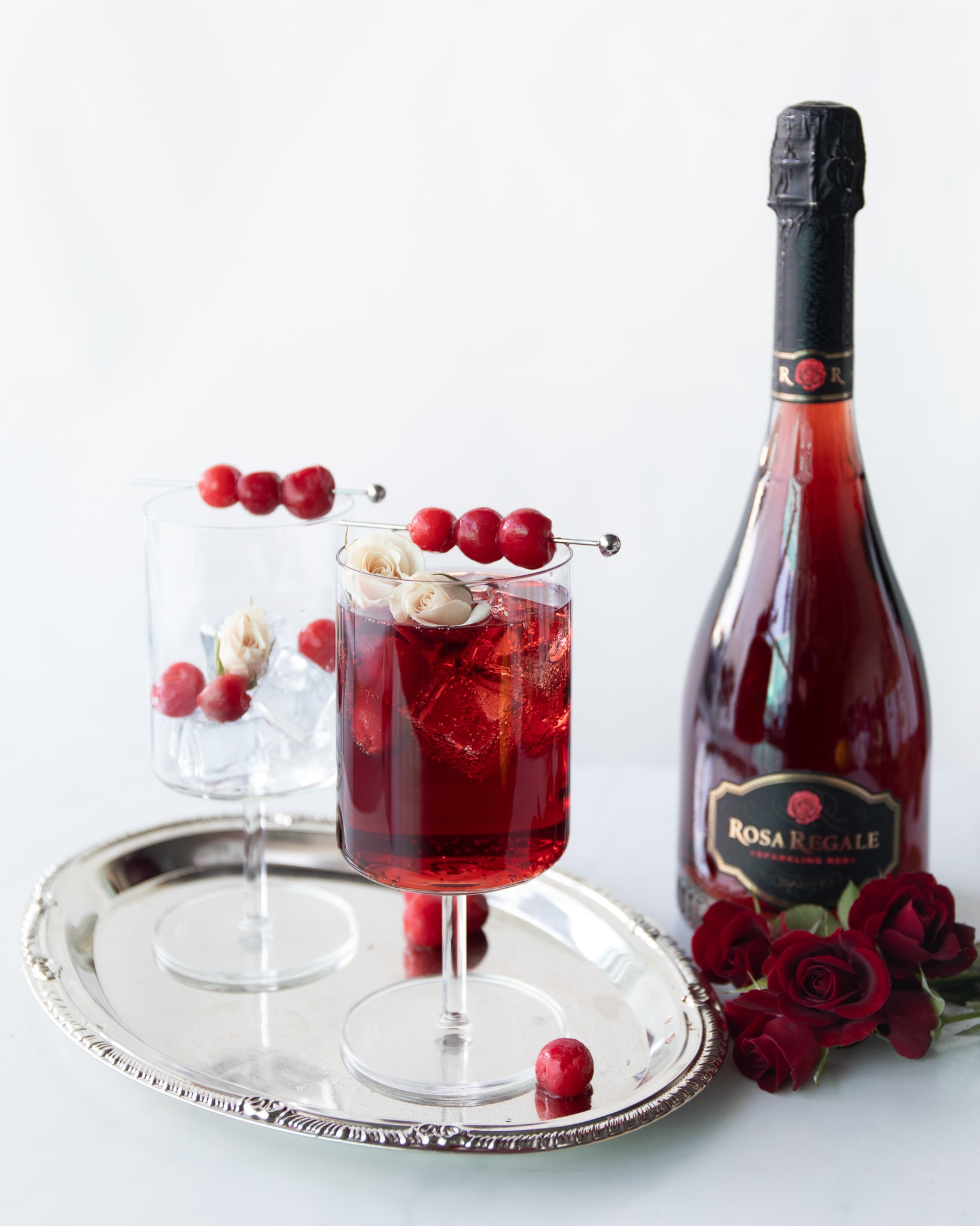 red cocktails with champagne bottle