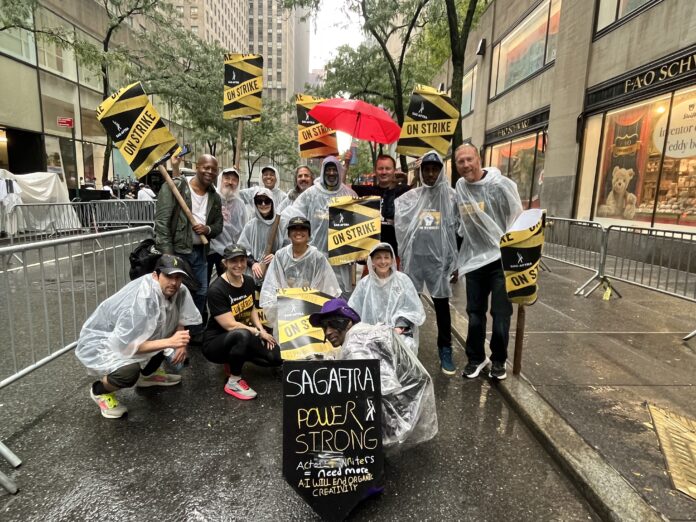 SAG AFRTRA strike a group of people holding SAG AFTRA signs