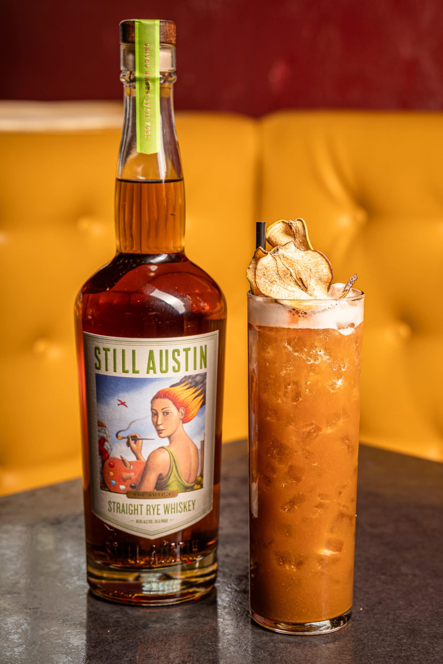 bourbon cocktail next to Still Austin Rye bottle