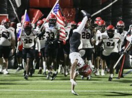 football team running onto field