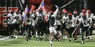 Cedar Hill Football Moves Closer to Playoff Spot With Win at Skyline football team running onto field