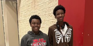 Devezin, Muhammad Earn All-State Thespian Honors two boys standing by a locker