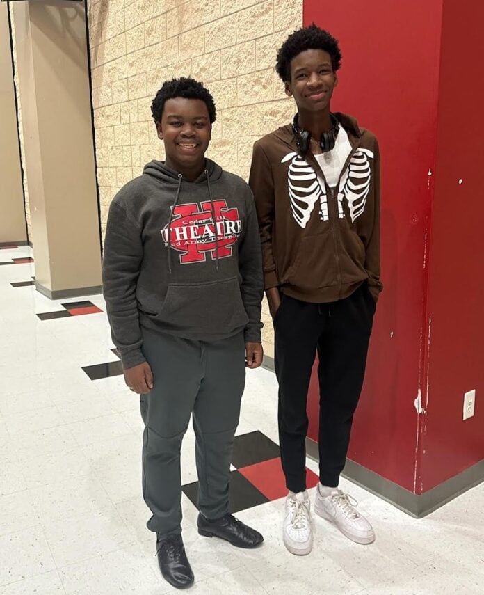 two boys standing by a locker