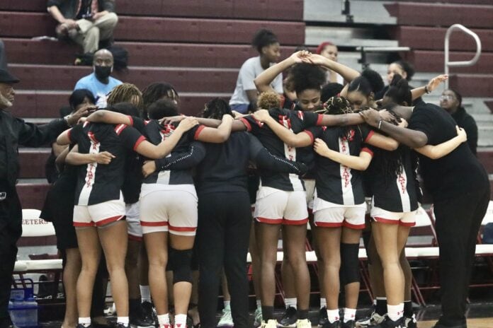 girls basketball team huddles