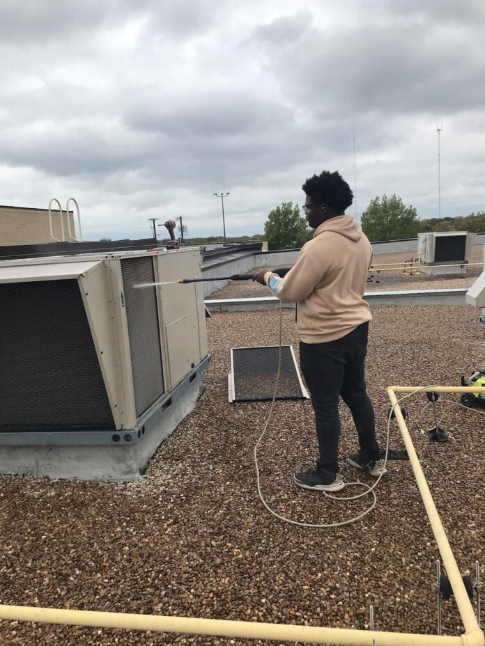 person working on HVAC unit