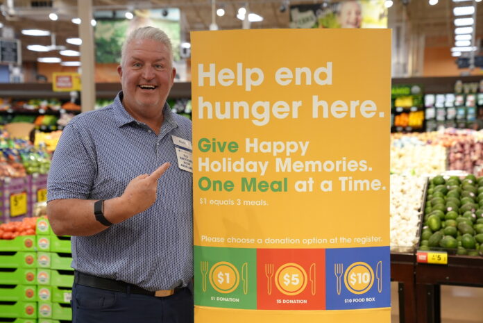man with help end hunger here sign