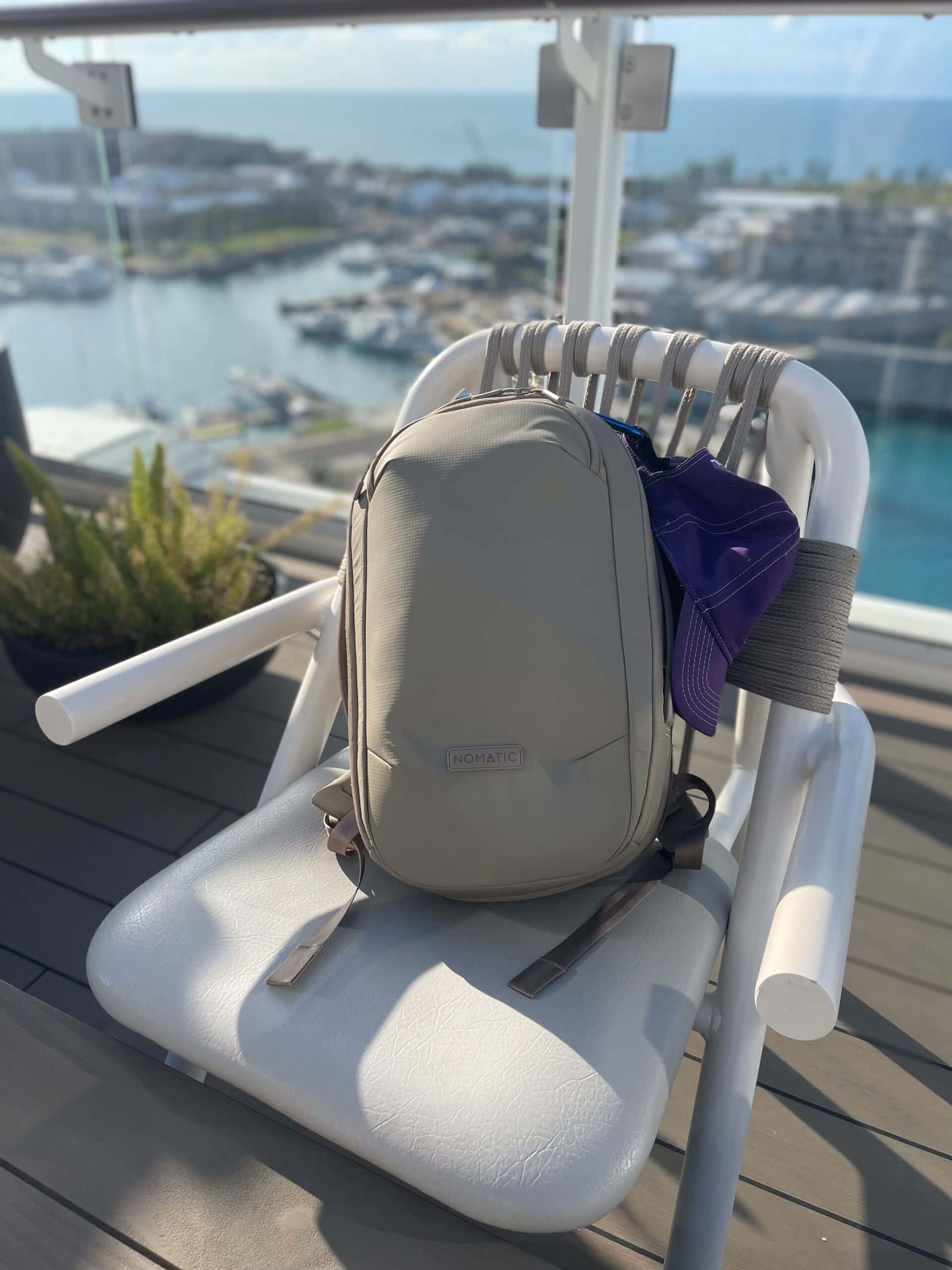 sand colored backpack from Nomatic in chair