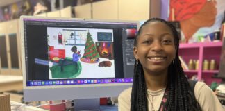 Cedar Hill High Sophomore Wins District Christmas Card Contest Zariel Williams with Christmas card design on computer monitor
