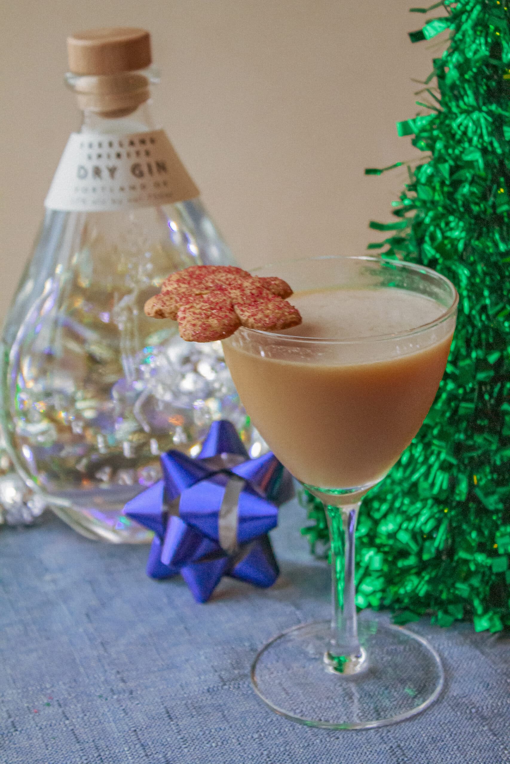 cocktail glass with gingerbread man garnish